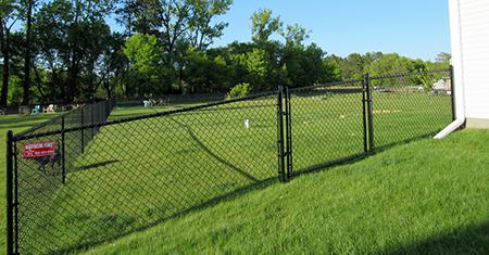 Black vinyl chain link fence with angle gate